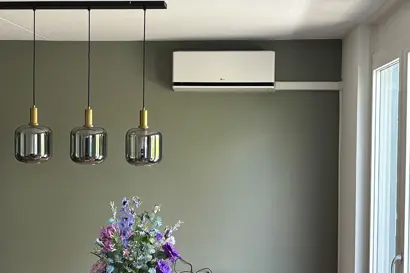 LG binnenunit woonkamer boven radiator met groene accentwand – Tilburg.jpg